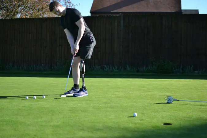 Chris, playing golf wearing his prosthetic leg