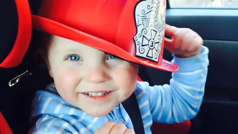 Lucien wearing a fireman's hat