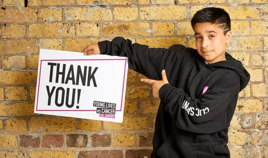Sofyan holding a thank you sign