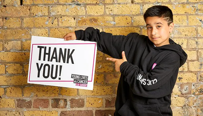 Sofyan holding a thank you sign