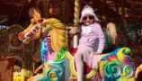 Imogen riding a carousel