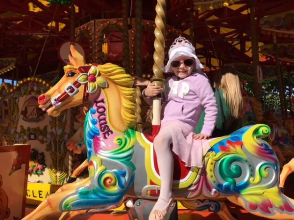 Imogen riding a carousel
