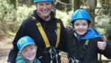 Oliver (right), his brother Ben and mum Nicky taking part in a woodland adventure course