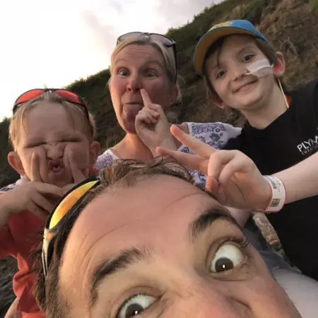 Oliver and his family taking a selfie and pulling silly faces