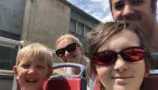 Oliver and his family on a sight-seeing bus trip