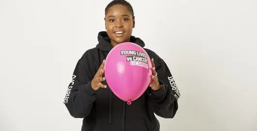 Michaela, a young person supported by CLIC Sargent, holding a balloon