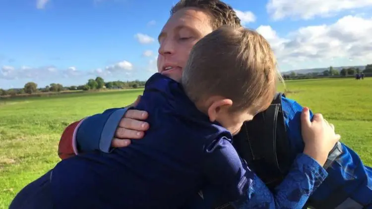 Tim and Michael hugging after Tim completes a skydive for CLIC Sargent