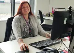 Social worker Jayne at a computer running our Live Chat service for children, young people and their parents with cancer