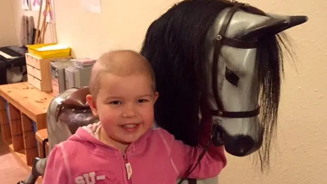 Elsa with the rocking horse at CLIC House in Bristol, where her family stayed whilst Elsa was on treatment.