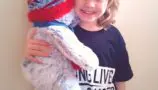 Ruby with her CLIC Sargent bear Pebbles