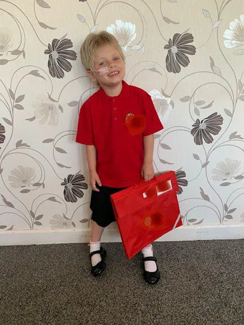 Isabella in her school uniform, grinning!