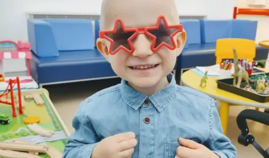 Young man with dark glasses shaped like stars. smiling!