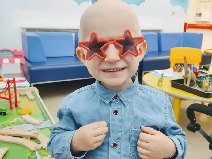 Young man with dark glasses shaped like stars. smiling!