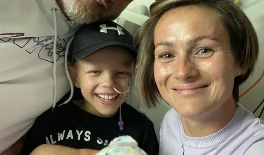A photo of Kara with her parents when her final chemo finished