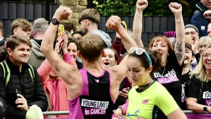 Runner being cheered along marathon route