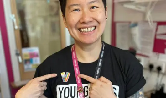 Young Lives vs Cancer Social Worker, Lyn, wears her new Pride badge