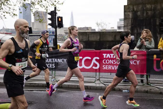 Young Lives vs Cancer London Marathon runner runs through the street