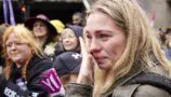 Woman in the London Marathon crowd is emotional