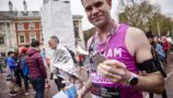 Young Lives vs Cancer London Marathon runner with their medal run