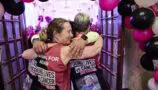 Young Lives vs Cancer London Marathon runners hug in celebration after the event
