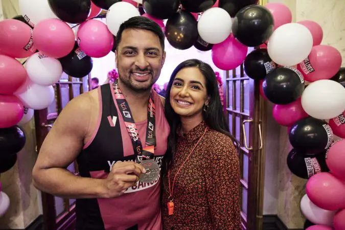 Young Lives vs Cancer London Marathon runner poses with their medal at the after party