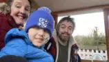 Nate pictured in a blue beanie with his mum Nicola and dad Phil