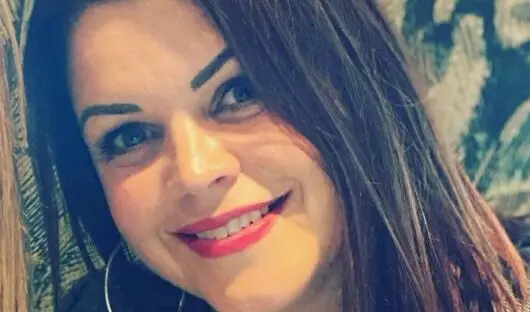 A photo of Dominique, her head is slightly tilted to the left and she is smiling at the camera.