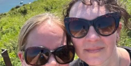 Louise and her friend on a sunny day by the sea
