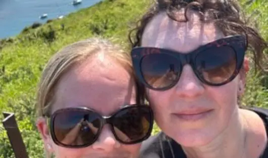 Louise and her friend on a sunny day by the sea