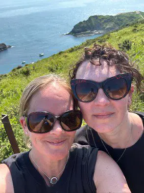 Louise and her friend on a sunny day by the sea