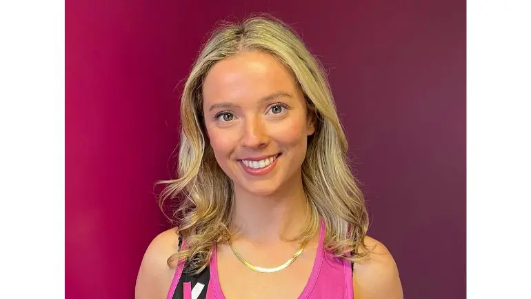 An image of Sophie. She is white with blonde hair, wearing a Young Lives vs Cancer running vest. She is looking straight ahead, smiling.