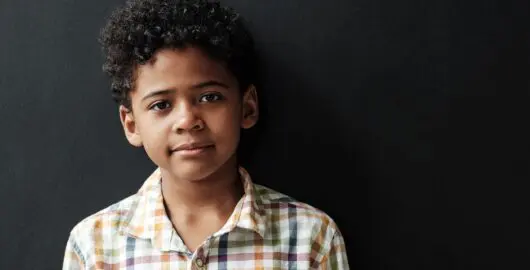Young person looking at camera depicting serious reflection
