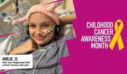 Amelie smiling with headphones and pink alien beanie. The text on the bottom right of the image says