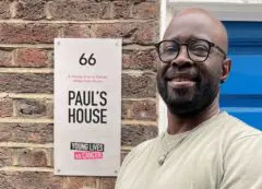 Eric, specialist social worker for Young Lives vs Cancer smiling outside Paul's House, a Homes from Home