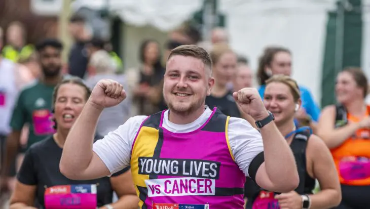 Runner taking part in an event wearing our Young Lives Vs Cancer Vest