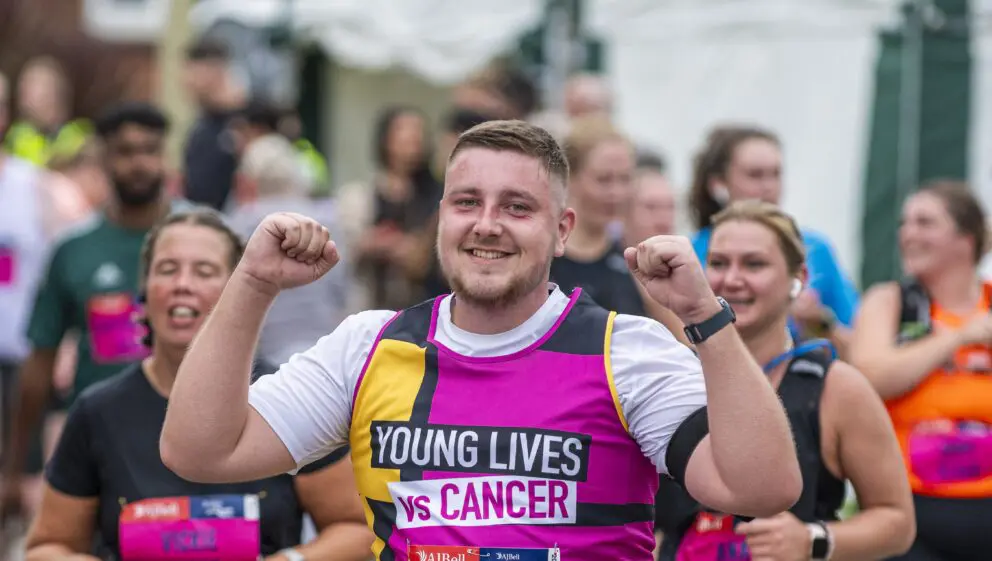 Runner taking part in an event wearing our Young Lives Vs Cancer Vest