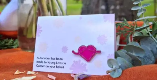 Young Lives vs Cancer pin badge used as a wedding favour