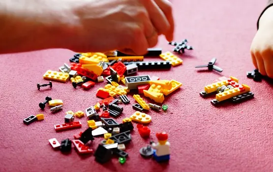 Adult and child playing with Lego