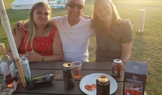 Photo of Abbie and her family sat in a garden