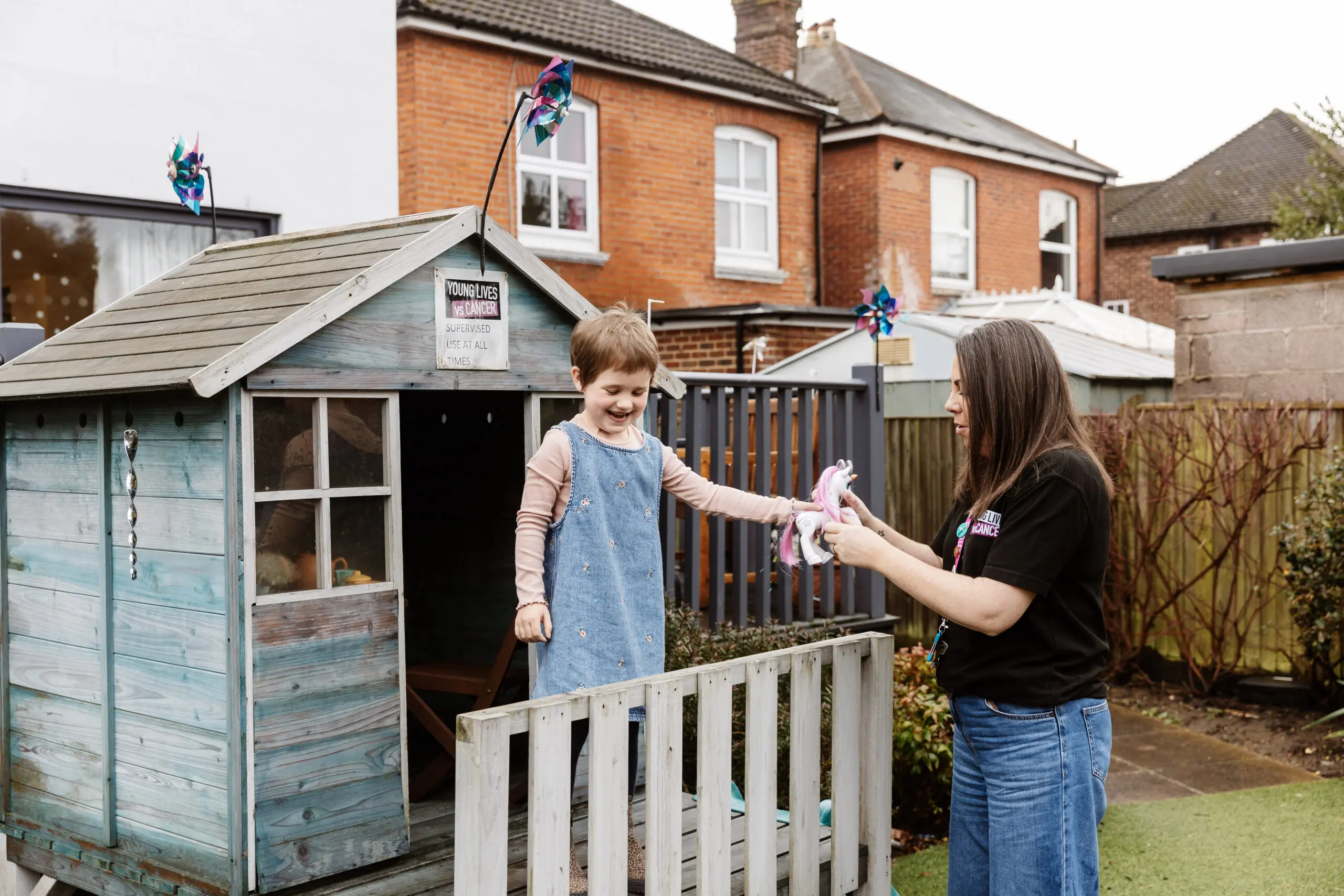Young Lives vs Cancer specialist social worker Nicky outside with Margot, a young per