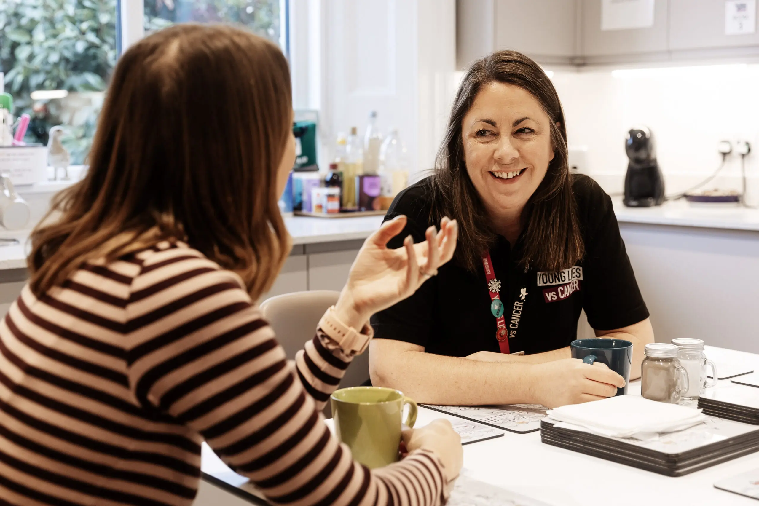 Young Lives vs cancer specialist social worker talking to the mother of Margot who is going through cancer treatment