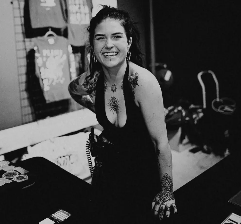 Black and white photo of Megan now with long hair and tattoos.