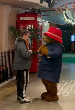 A photograph of 17 year old Jack meeting Paddington Bear