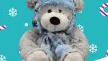 A grey bear with a blue hat and scarf