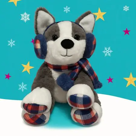 A grey and white bear wearing tartan ear muffs and scarf
