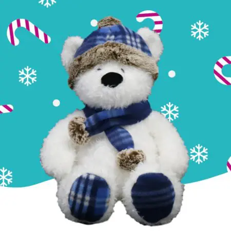 A white bear wearing a navy blue scarf and hat