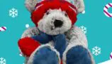 A grey bear wearing a blue scarf and a blue and red hat