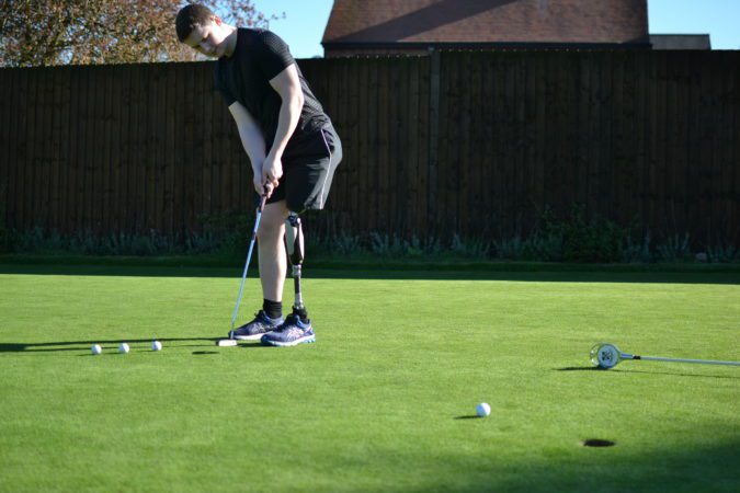 Chris, playing golf wearing his prosthetic leg