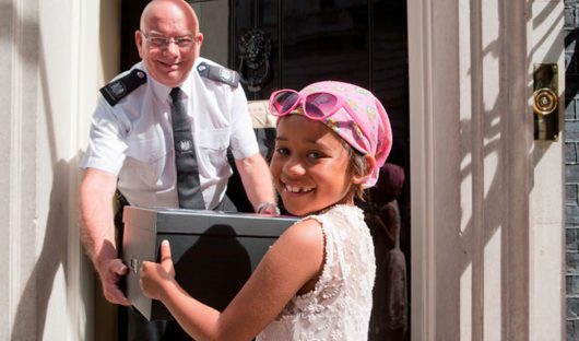 Young cancer patient Khianna handing in a CLIC Sargent petition at Number 10 Downing Street