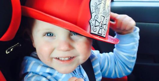 Lucien wearing a fireman's hat
